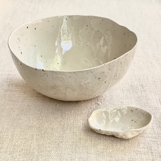 Unique handmade natural ceramic bowl from the Amazon collection. This large bowl made of speckled clay enriches your table setting with an authentic natural feel or will surprise someone as a personal ceramic gift. A one of a kind signature piece of tableware with a unique design and white porcelain slib