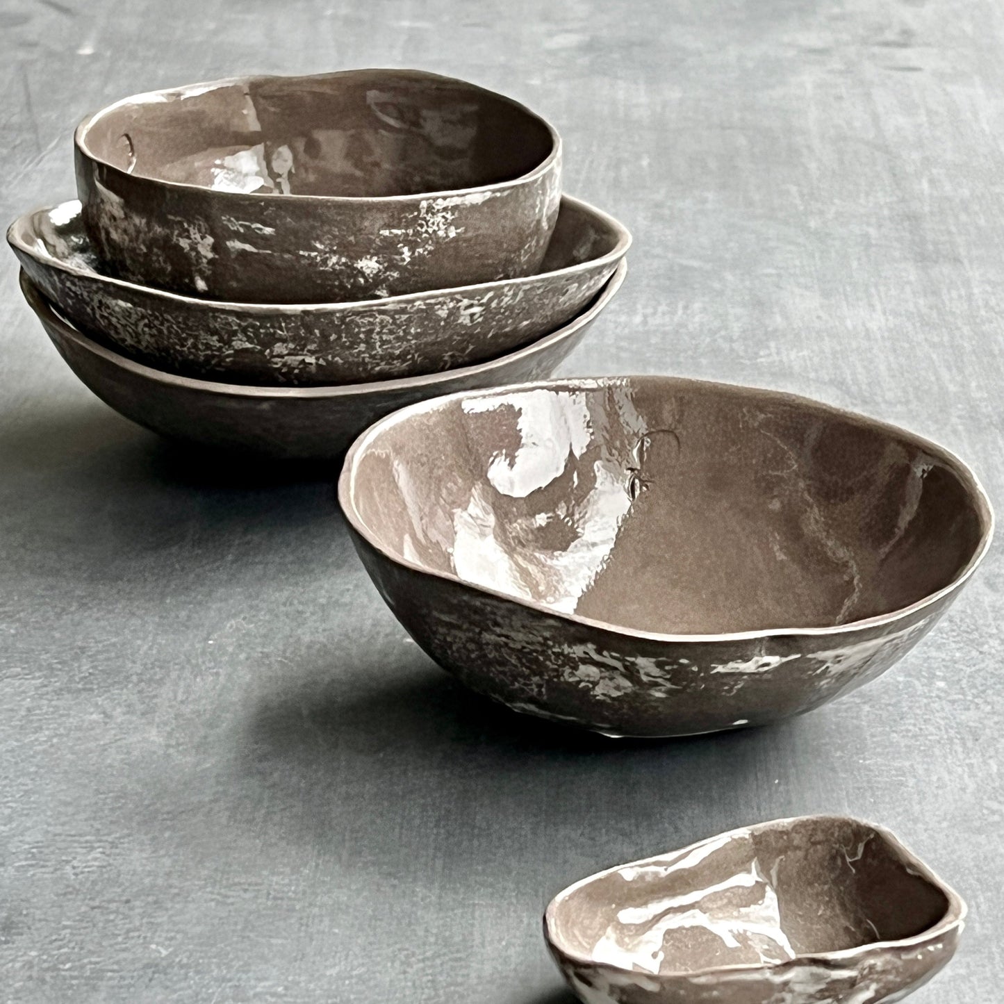 Unique handmade grey-brown ceramic bowl from the Amazon collection. This small bowl made of grey-brown clay enriches your table setting with a rich earthy feel or will surprise someone as a personal ceramic gift. A one of a kind signature piece of tableware with a unique design and white porcelain slib