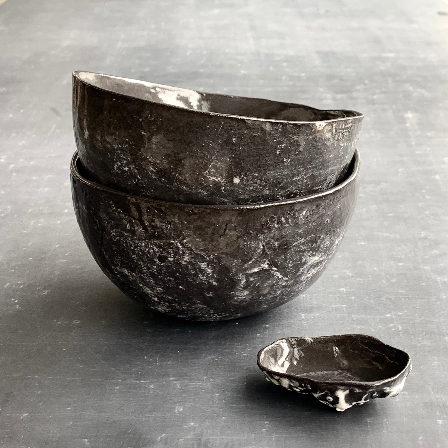 Unique handmade black ceramic bowl from the Amazon collection. This large bowl made of black clay enriches your table setting with a mysterious magical feel or will surprise someone as a personal ceramic gift. A one of a kind signature piece of tableware with a unique design and white porcelain slib.