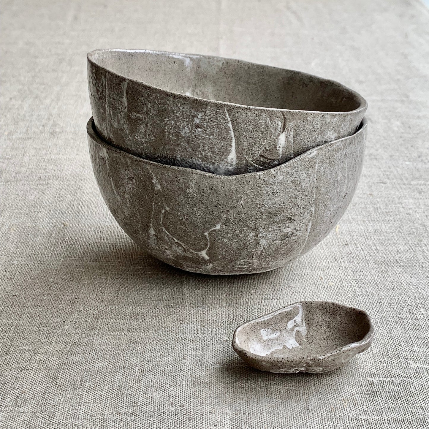 Unique handmade grey ceramic bowl from the Amazon collection. This large bowl made of grey clay enriches your table setting with a deep warm feel or will surprise someone as a personal ceramic gift. A one of a kind signature piece of tableware with a unique design and white porcelain slib