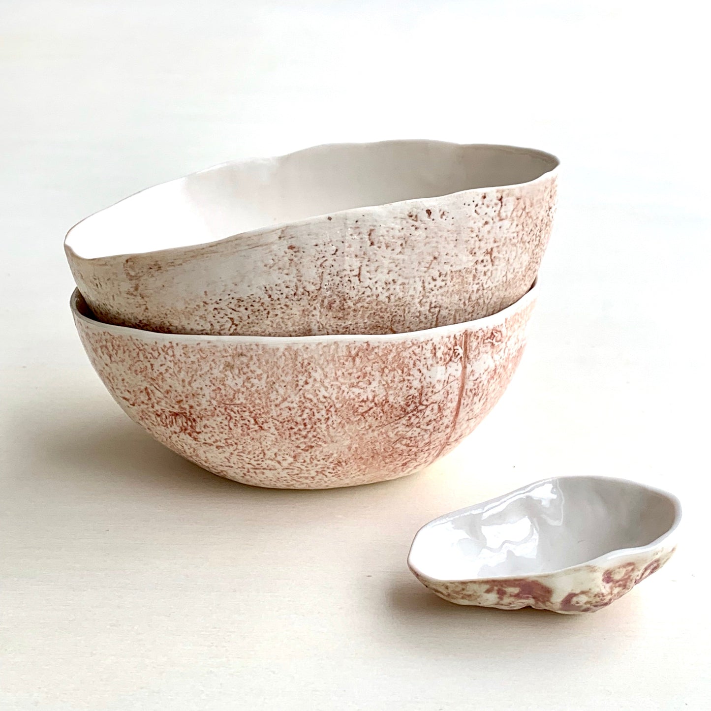 Unique handmade white porcelain ceramic bowl from the Amazon collection. This medium bowl made of porcelain enriches your table setting with an elegant organic feel or will surprise someone as a personal ceramic gift. A one of a kind signature piece of tableware with a unique design and earth pigment