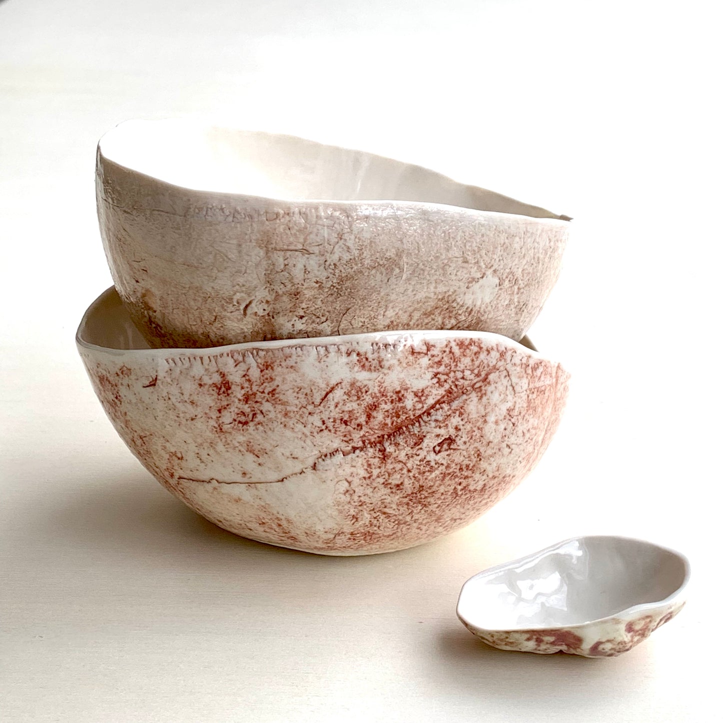 Unique handmade white porcelain ceramic bowl from the Amazon collection. This large bowl made of porcelain enriches your table setting with an elegant organic feel or will surprise someone as a personal ceramic gift. A one of a kind signature piece of tableware with a unique design and earth pigment