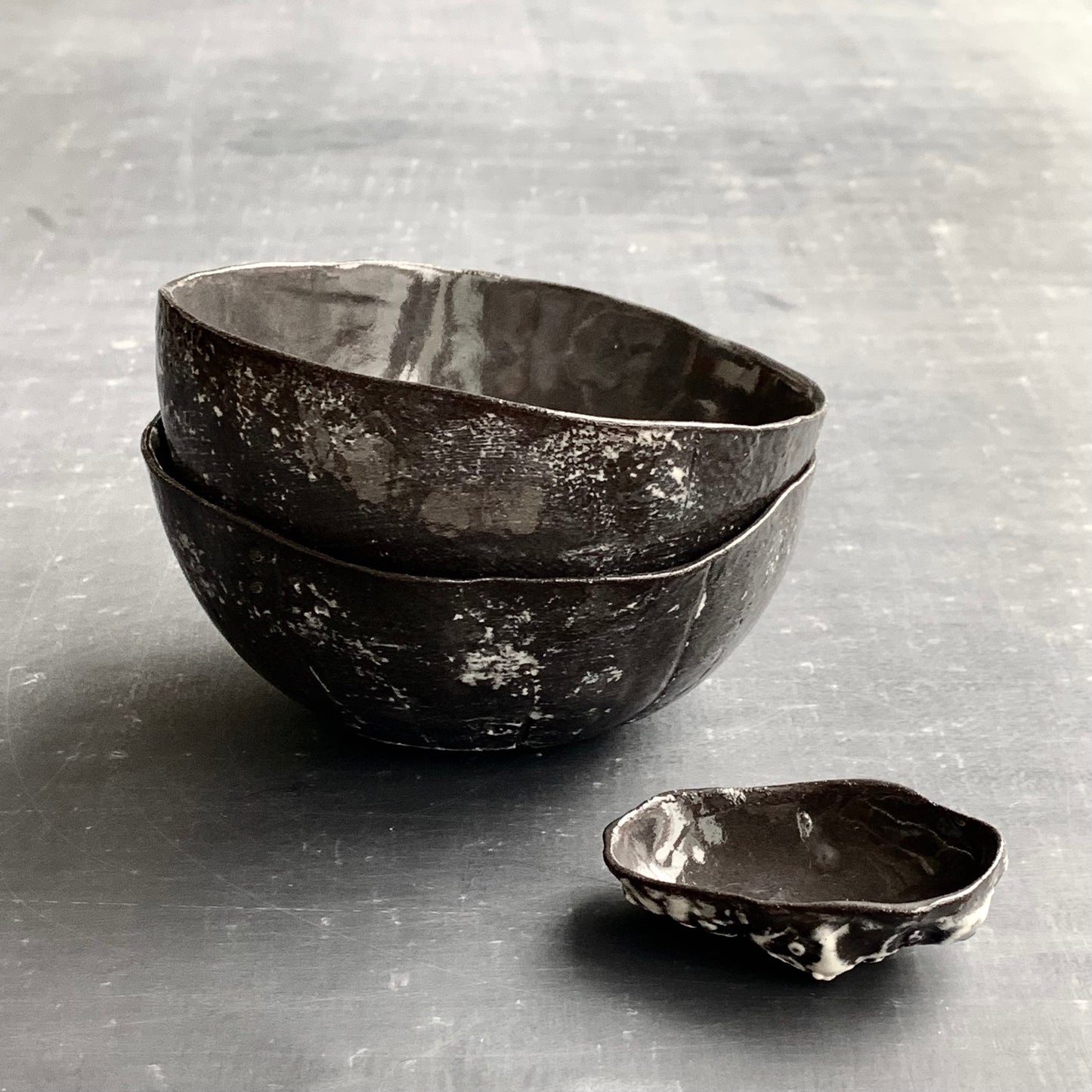 Unique handmade black ceramic bowl from the Amazon collection. This medium bowl made of black clay enriches your table setting with a mysterious magical feel or will surprise someone as a personal ceramic gift. A one of a kind signature piece of tableware with a unique design and white porcelain slib