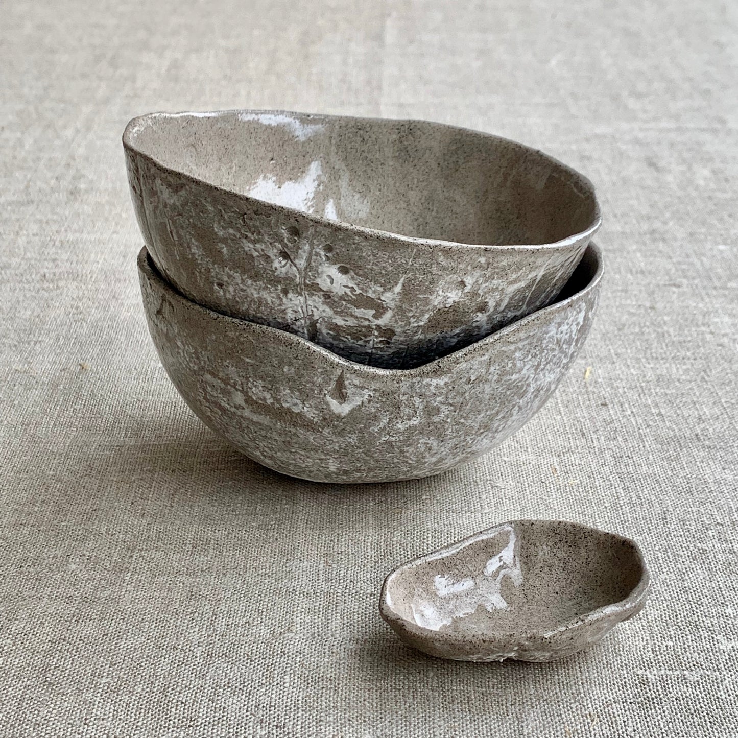 Unique handmade grey ceramic bowl from the Amazon collection. This medium bowl made of grey clay enriches your table setting with a deep warm feel or will surprise someone as a personal ceramic gift. A one of a kind signature piece of tableware with a unique design and white porcelain slib