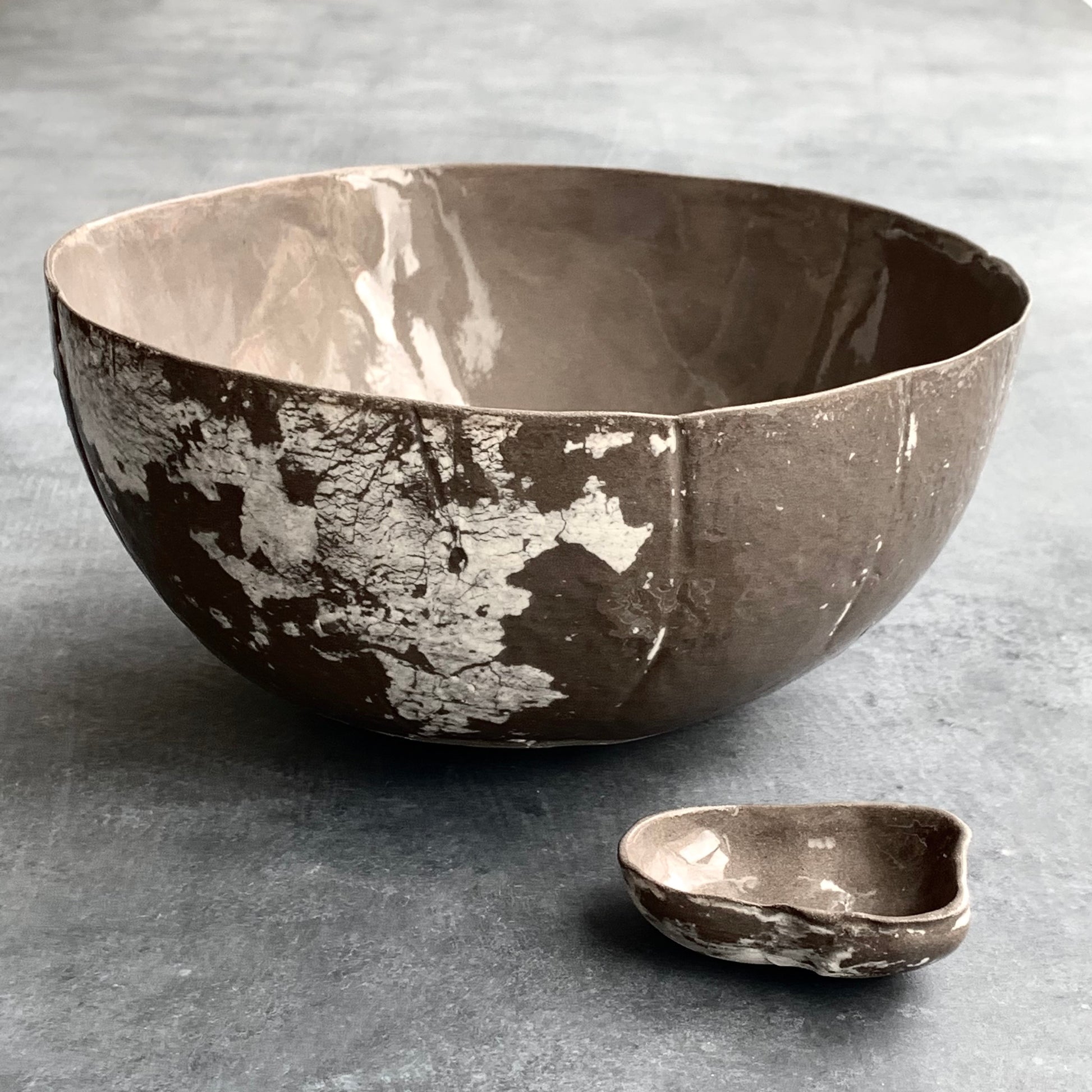 Unique handmade grey-brown ceramic bowl from the Amazon collection. This extra large bowl made of grey-brown clay enriches your table setting with a rich earthy feel or will surprise someone as a personal ceramic gift. A one of a kind signature piece of tableware with a unique design and white porcelain slib