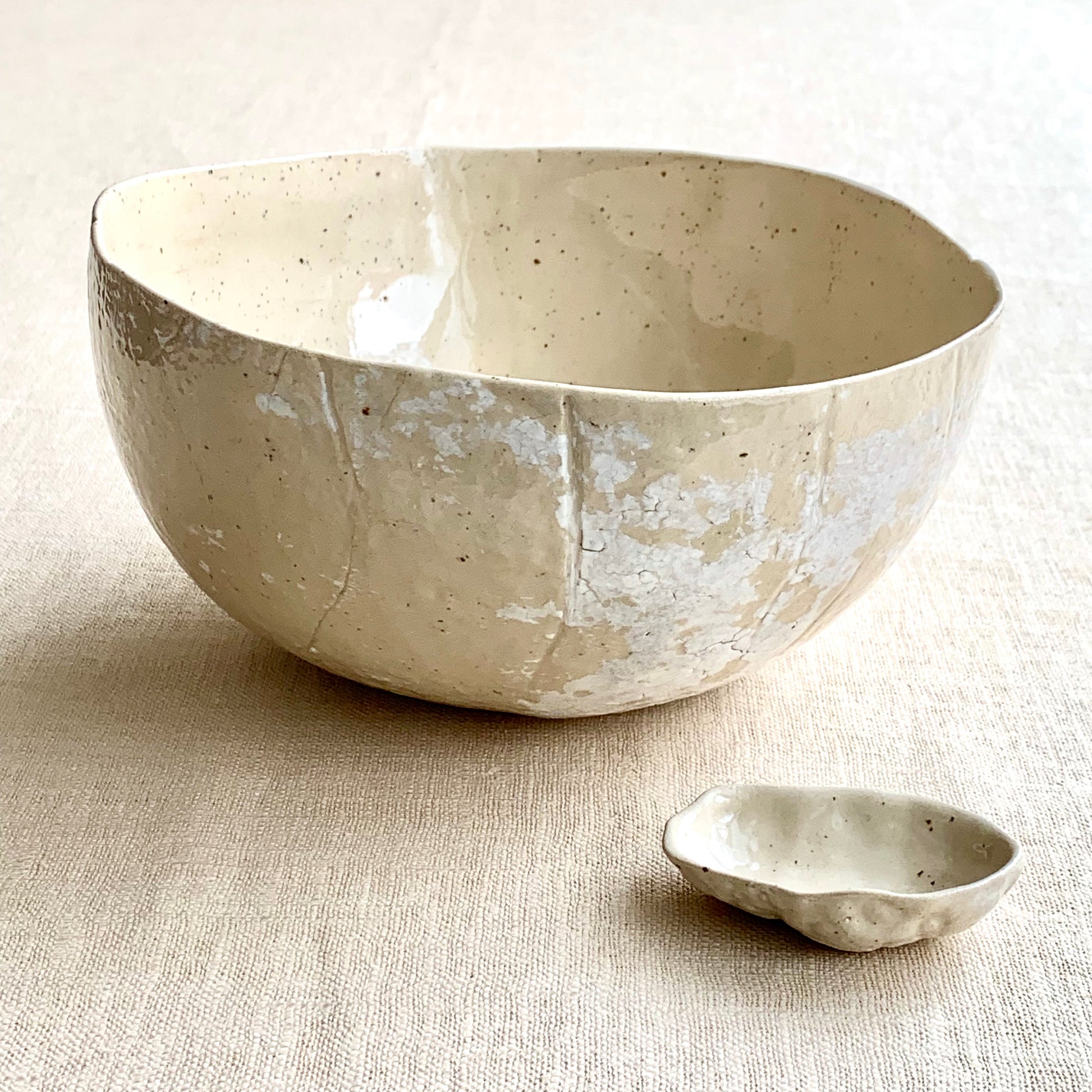 Unique handmade natural ceramic bowl from the Amazon collection. This extra large bowl made of speckled clay enriches your table setting with an authentic natural feel or will surprise someone as a personal ceramic gift. A one of a kind signature piece of tableware with a unique design and white porcelain slib