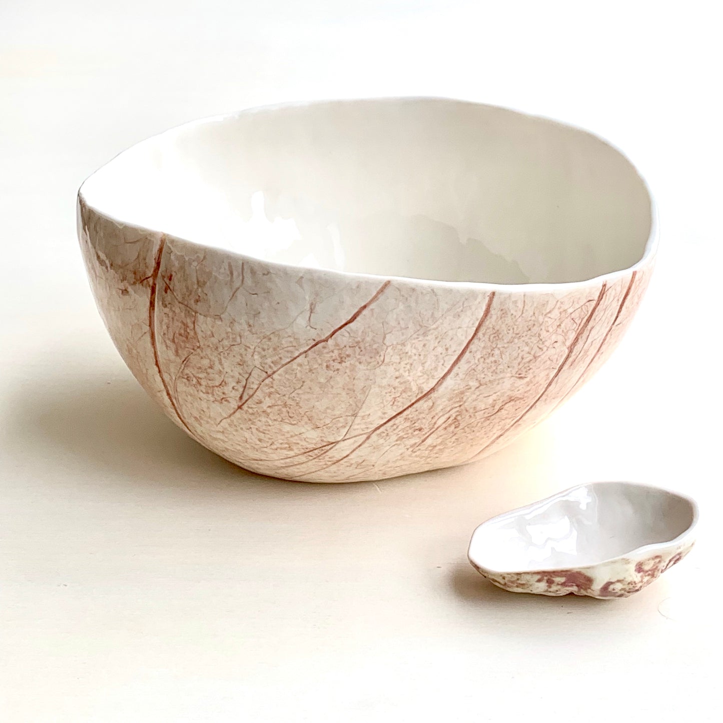Unique handmade white porcelain ceramic bowl from the Amazon collection. This extra large bowl made of porcelain enriches your table setting with an elegant organic feel or will surprise someone as a personal ceramic gift. A one of a kind signature piece of tableware with a unique design and earth pigment
